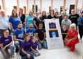 Representantes de peñas y colectivos de Santander posan junto al cartel oficial de las Fiestas de la Virgen del Mar 2024, patrona de la ciudad, durante su presentación oficial en un acto institucional.