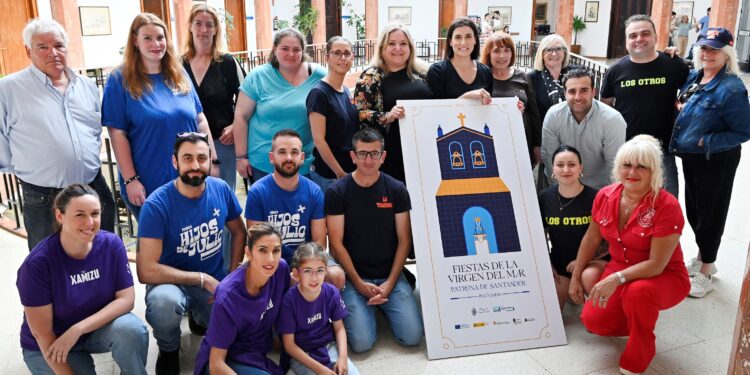 Representantes de peñas y colectivos de Santander posan junto al cartel oficial de las Fiestas de la Virgen del Mar 2024, patrona de la ciudad, durante su presentación oficial en un acto institucional.